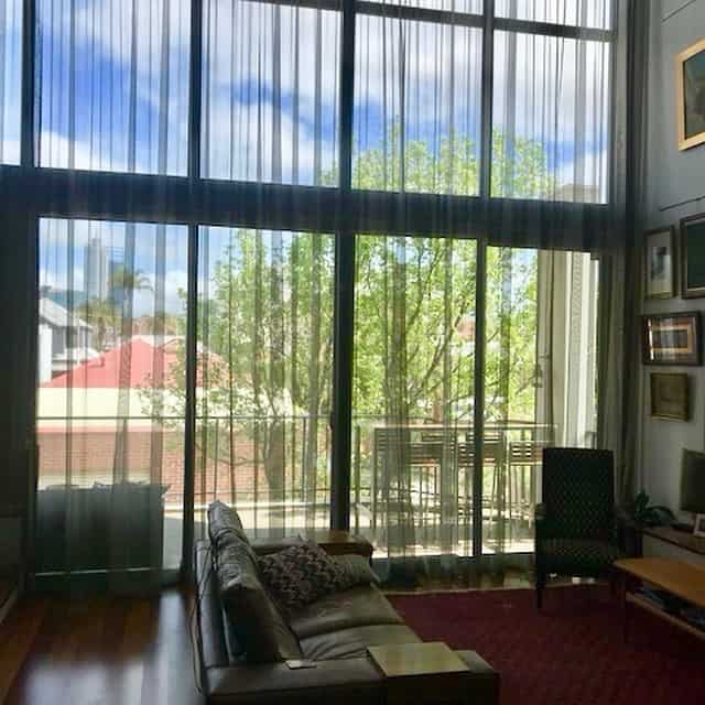 Sheer curtains across a large window in a Perth living room
