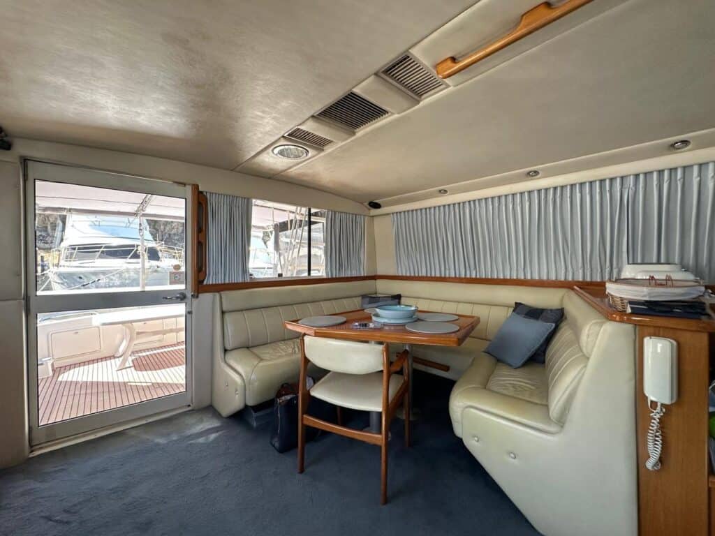 Pleated curtains fitted to the windows of a boat's helm and study area
